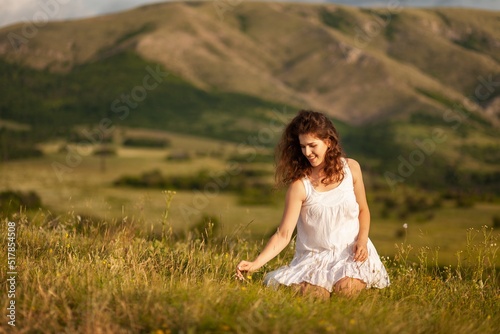 Woman in the field with flowers on mount background