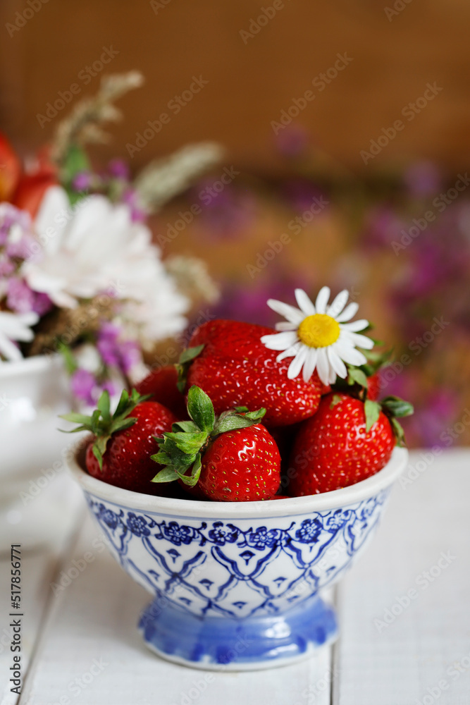 A bowl with strawberries on the table. A bowl with strawberries on the table.