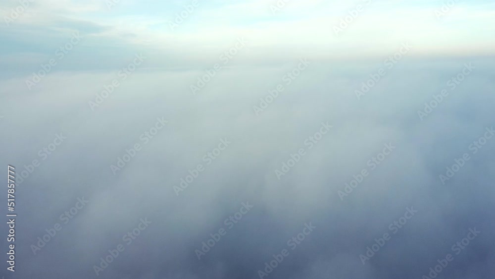 Aerial drone view flight over fog. Flight between white fluffy fog mist and clouds in blue sky on sunny day. Natural abstract background. Cloudy weather. Atmosphere. Top view fog movement. Timelapse. Aerial drone view flight over fog. Flight between white fluffy fog mist and clouds in blue sky on sunny day. Natural abstract background. Cloudy weather. Atmosphere. Top view fog movement. Timelapse.