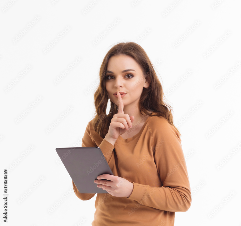 A girl on a white background communicates through a tablet. A girl on a white background communicates through a tablet.