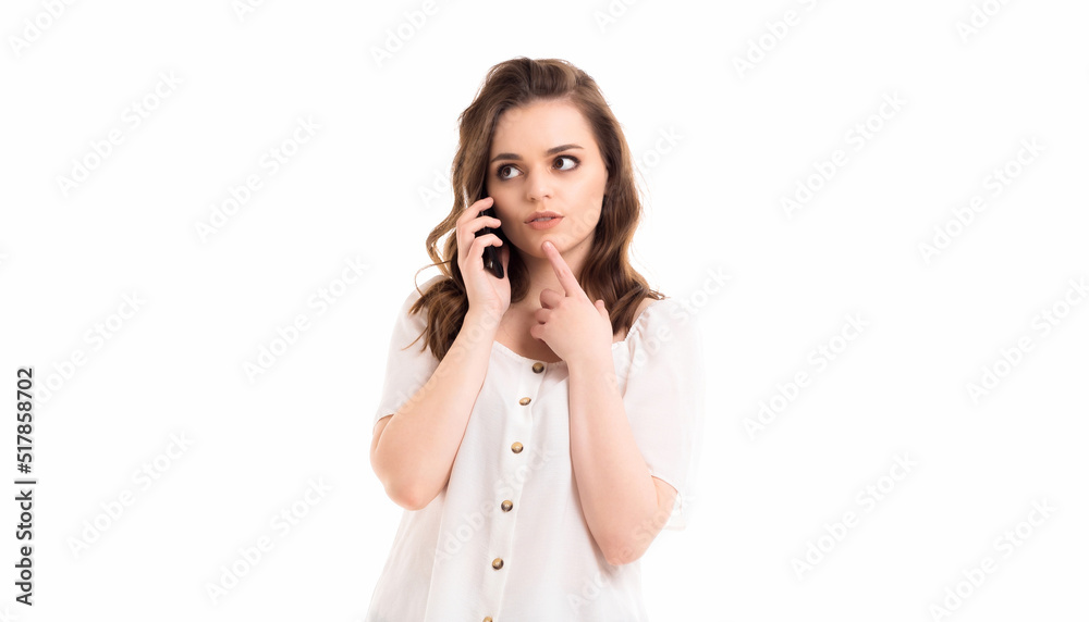 A woman communicates on a mobile phone. Emotions in communication. Girl on a white background. A woman communicates on a mobile phone. Emotions in communication. Girl on a white background.