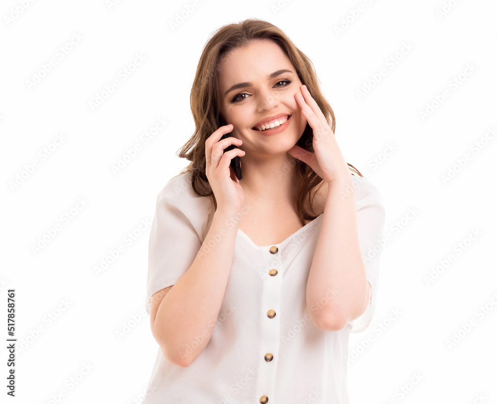 A woman communicates on a mobile phone. Emotions in communication. Girl on a white background. A woman communicates on a mobile phone. Emotions in communication. Girl on a white background.