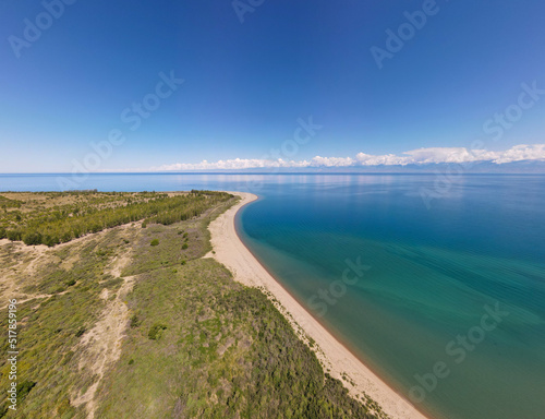 Top view of the sandy beach and Issyk-Kul lake
