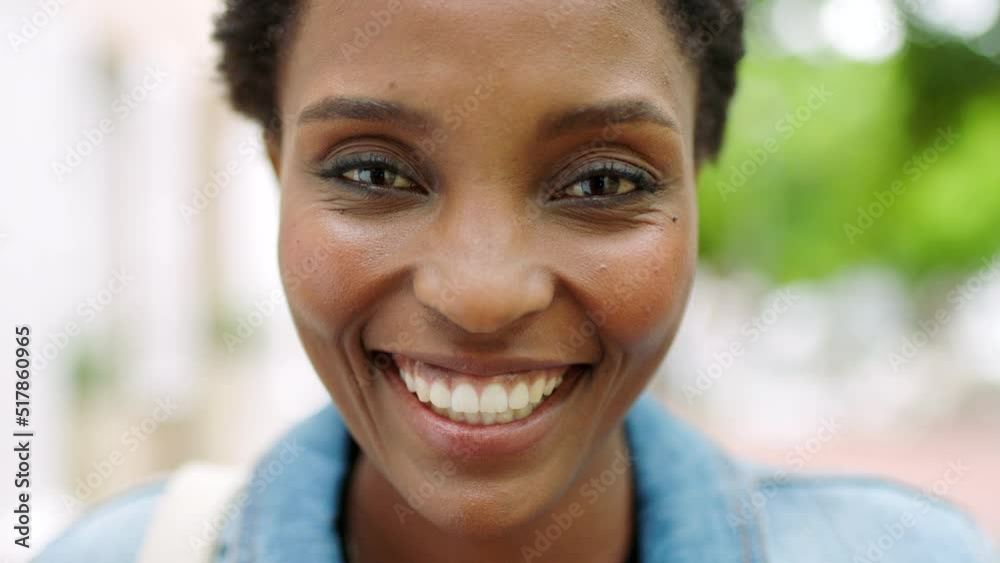 Portrait of a beautiful girl standing and commuting in the city. One smiling stylish black female with an afro relaxing downtown. Trendy young woman showing her teeth laughing and traveling in town Portrait of a beautiful girl standing and commuting in the city. One smiling stylish black female with an afro relaxing downtown. Trendy young woman showing her teeth laughing and traveling in town