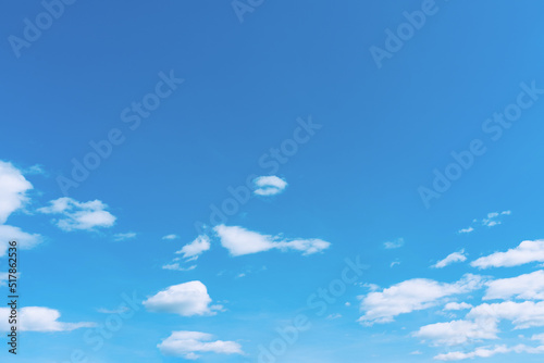 White clouds in the blue sky. White light cloudy heaven,good weather. Summer sky. Heaven and infinity. Curly clouds on a sunny day. Beautiful bright blue background.