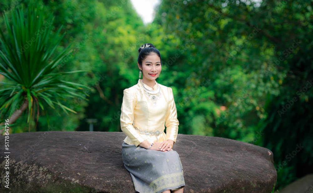 Thai dress sitting on the grass Thai dress sitting on the grass
