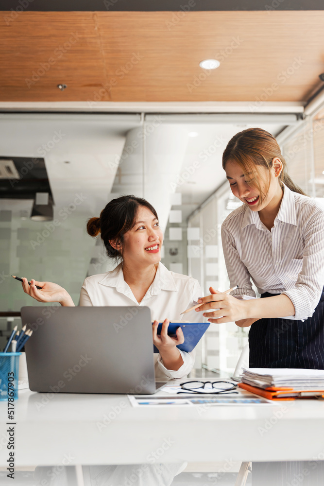 Business Asian discussing in modern office, small group asian female sale team staff smart solving plan data graph chart result job report talk on desk table at office. Business Asian discussing in modern office, small group asian female sale team staff smart solving plan data graph chart result job report talk on desk table at office.