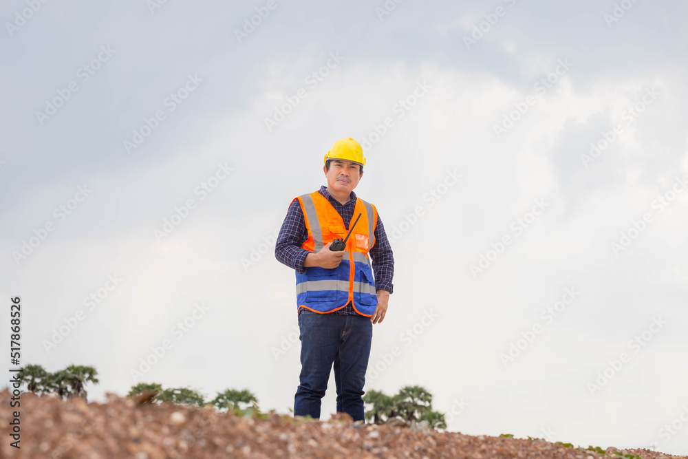 Construction engineer checking project at the building site, Foreman worker in hardhat at the infrastructure construction site Construction engineer checking project at the building site, Foreman worker in hardhat at the infrastructure construction site