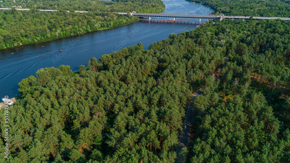 Aerial view summer forest and river in sunny day. Drone shot beautiful nature landscape, green trees Aerial view summer forest and river in sunny day. Drone shot beautiful nature landscape, green trees