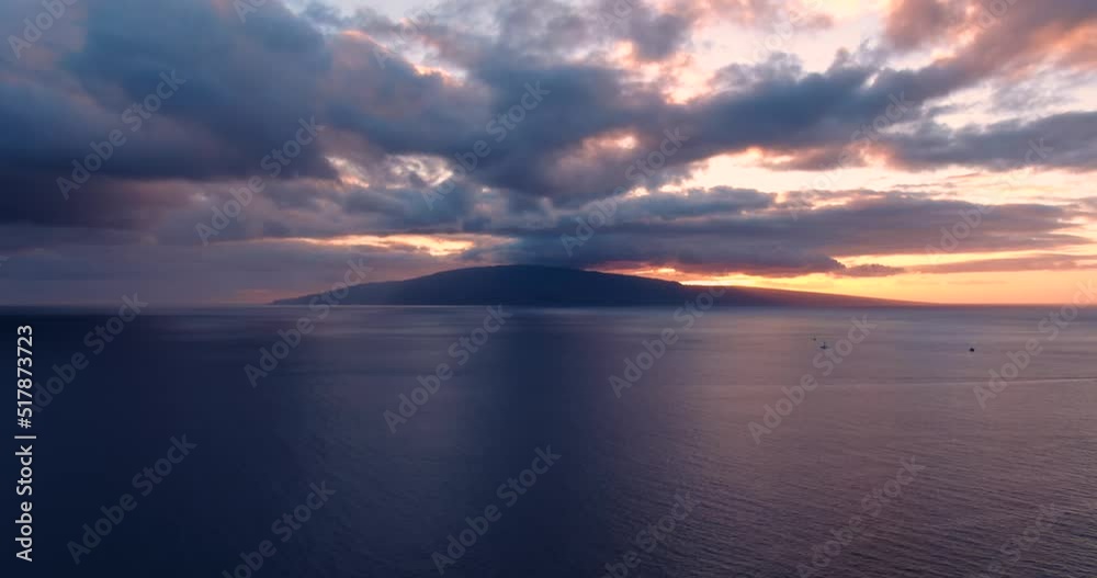 aerial views of bleeding orange sunset behind lanai island with sailboats aerial views of bleeding orange sunset behind lanai island with sailboats