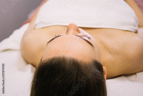 Woman receiving facial massage in beauty salon.Beauty and skincare concept with a beautiful woman. Middle aged female relaxed with massage for facial lifting