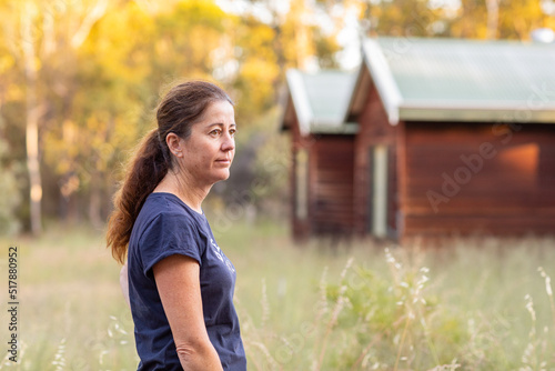 stressed middle-aged woman outside her home photo