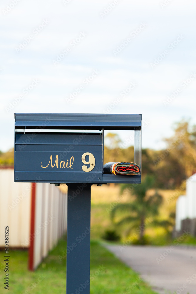 Number 9 mail box in front of long driveway with junk mail catalog Number 9 mail box in front of long driveway with junk mail catalog