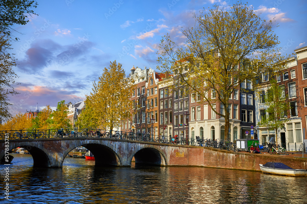 Bridge over channel in Amsterdam Netherlands houses river Amstel landmark old european city spring landscape.
