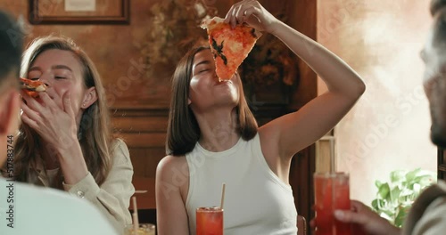 Group of friend, tasting delicious italian pizza in the restaurant during meet