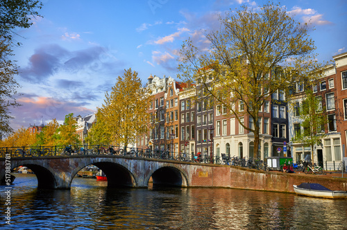 Bridge over channel in Amsterdam Netherlands houses river Amstel landmark old european city spring landscape.