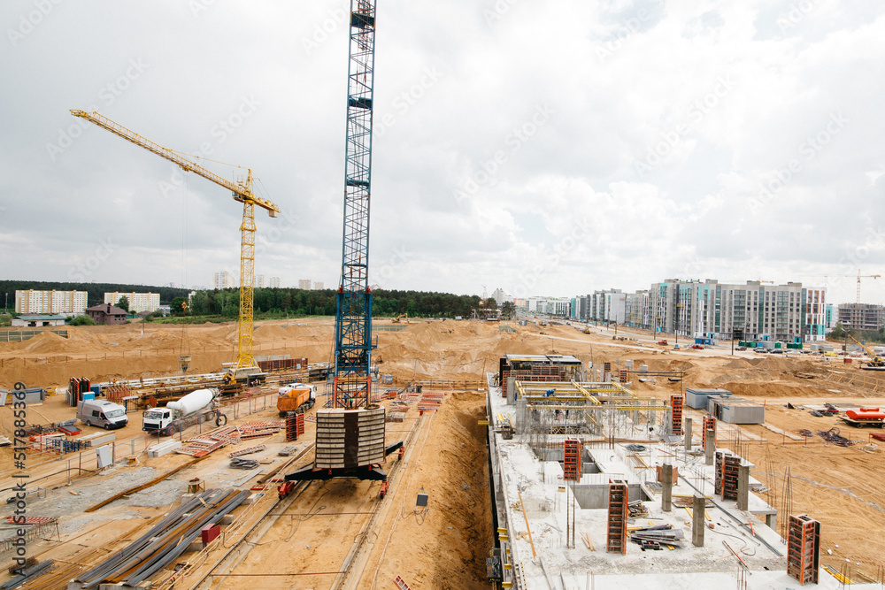 Construction site with high cranes. Construction of modern apartment buildings 