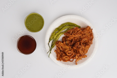 Kanda Bhajia In Plate With Green Chutney and imli [tamarind] Chutney photo