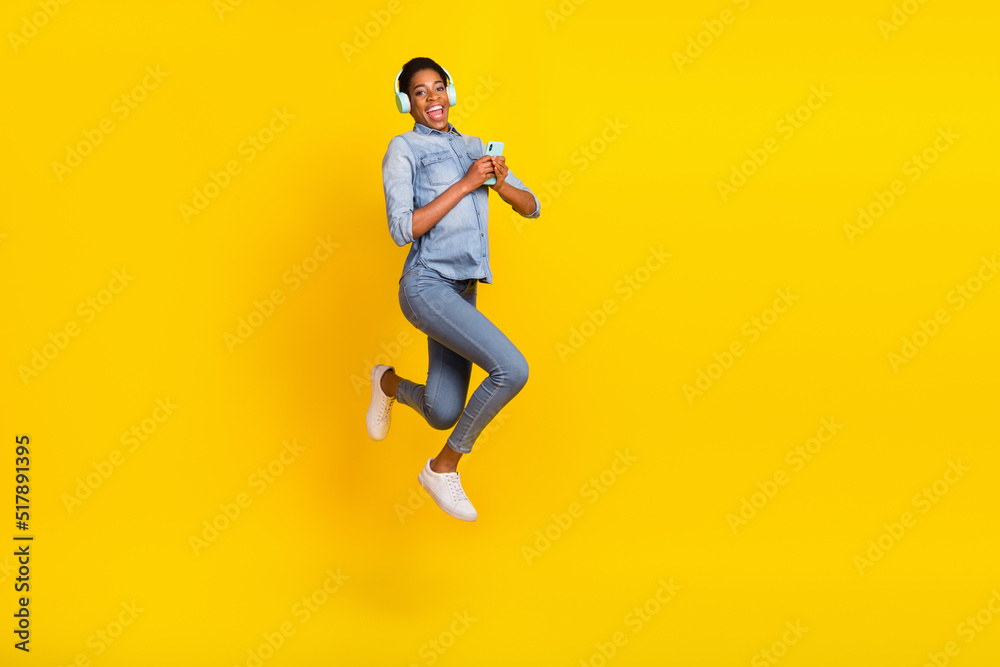 Portrait of excited energetic person hold telephone enjoy free time summer isolated on yellow color background