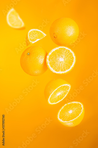 Orange fruits in flight.  Creative levitation food on orange background. 7 fruits
