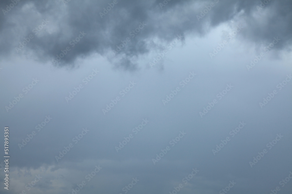 Atmosphere and formation of rain. Low hanging clouds with rain on the background of a gray sky. Rain clouds, texture, background. Gray sky and bad weather in summer. Climate change Atmosphere and formation of rain. Low hanging clouds with rain on the background of a gray sky. Rain clouds, texture, background. Gray sky and bad weather in summer. Climate change