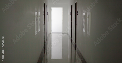Photography white hotel hallway with many doors and lights