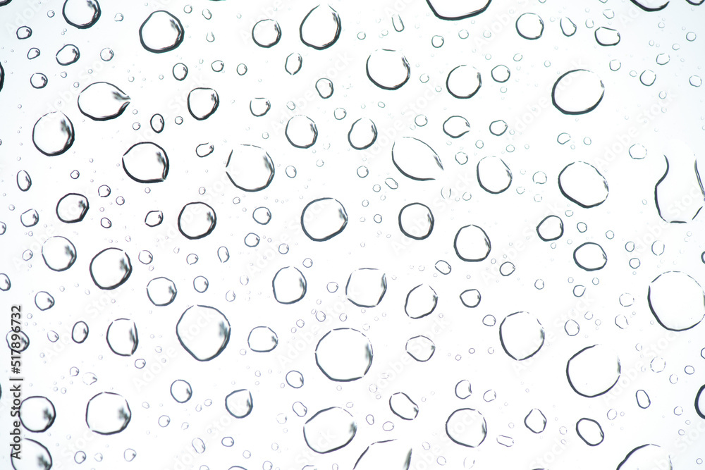 Water droplets on glass and on the sky background.