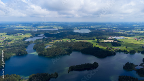 drone shot of the "Langbürgner See" (lake) with little villages and forest, landscape