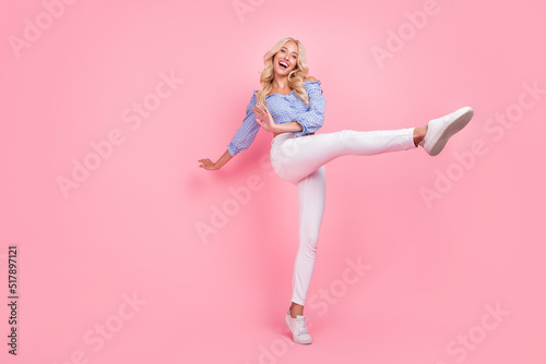 Full length photo of lovely adorable girl dressed blue top dancing walking isolated pink color background