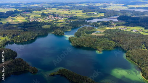 drone shot of the "Langbürgner See" (lake) with little villages and forest