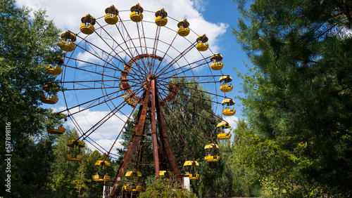 Ferris wheel in the ghost city of Pripyat after explosion of the fourth reactor Chernobyl nuclear power plant. Exclusion radioactive zone on a sunny summer day, Ukraine. Radiation, catastrophe
