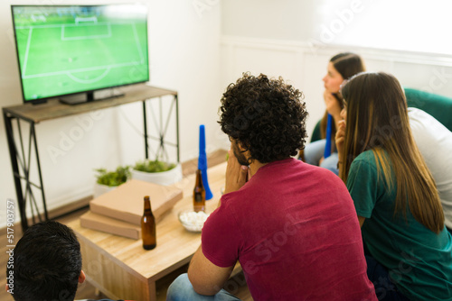 Sports fans looking worried while watching the soccer championship photo