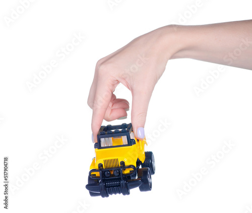 Yellow toy car in hand on white background isolation