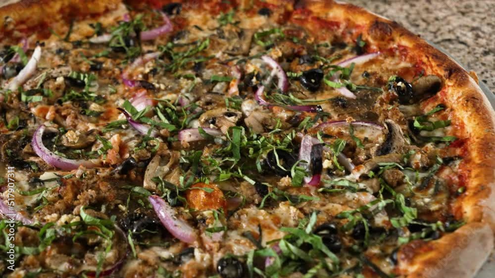 Large New York Style pizza topped with mushrooms onions and fresh chopped basil, slider close up 4K Large New York Style pizza topped with mushrooms onions and fresh chopped basil, slider close up 4K
