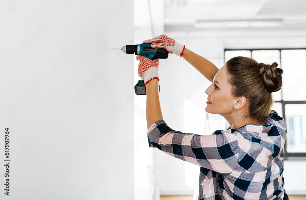 repair, construction and building concept - woman or builder with perforator drilling wall at home repair, construction and building concept - woman or builder with perforator drilling wall at home