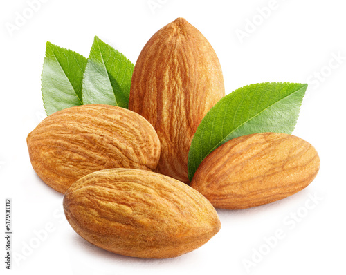 Close-up of delicious almonds with leaves, isolated on white background