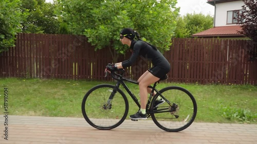 Young stylish brunette woman rides bike