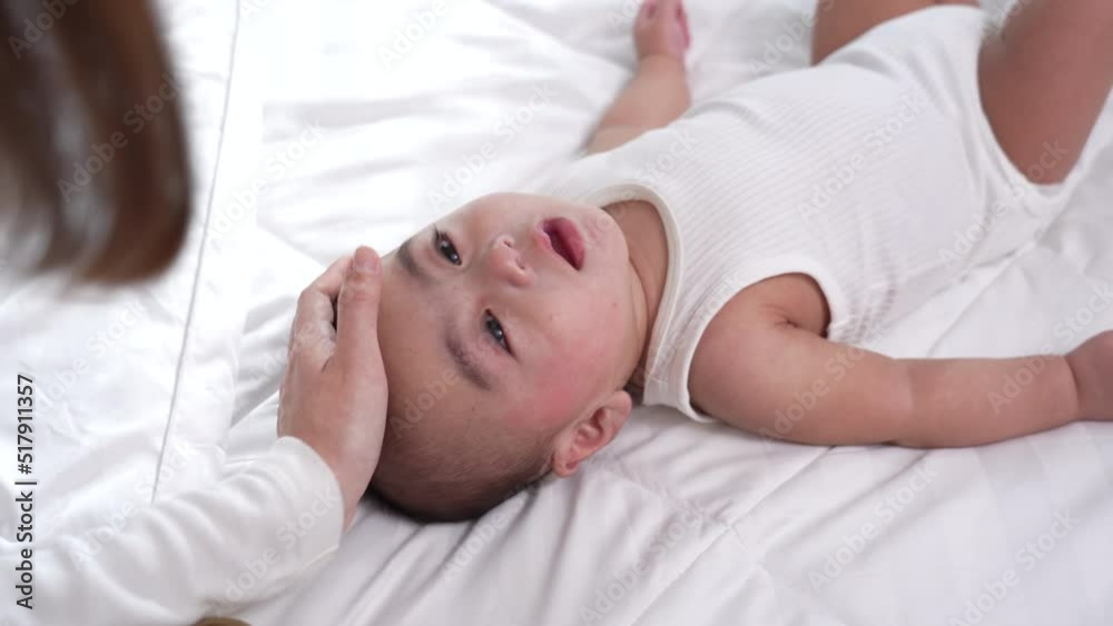 Smiling of newborn baby or cute little lying on a white bed at home. Infant child portrait happy concept, Healthy childcare in the morning. Smiling of newborn baby or cute little lying on a white bed at home. Infant child portrait happy concept, Healthy childcare in the morning.