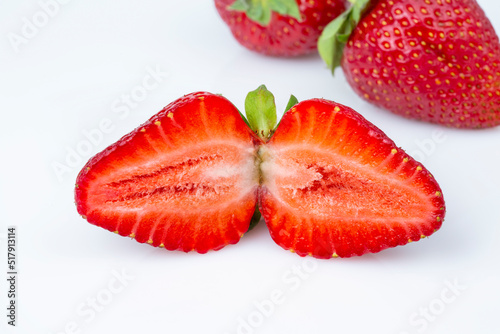 Group of summer fresh juicy strawberries in a cut on a white isolated background