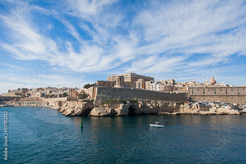 View of Malta from the water with old buildings near the water.