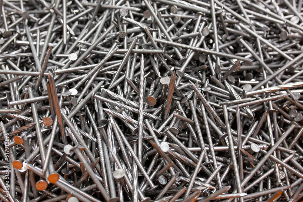 A lot of silver metal tack nails. Construction background A lot of silver metal tack nails. Construction background