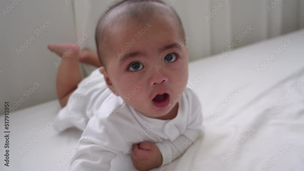 Smiling of newborn baby or cute little lying on a white bed at home. Infant child portrait happy concept, Healthy childcare in the morning. Smiling of newborn baby or cute little lying on a white bed at home. Infant child portrait happy concept, Healthy childcare in the morning.