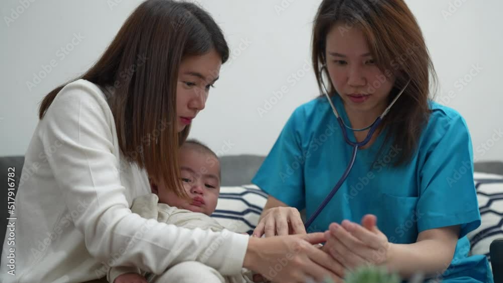 Asian Female doctor pediatrician holding stethoscope checkup child newborn baby boy patient visit doctor with mother at home, mom protection children medical care concept. Asian Female doctor pediatrician holding stethoscope checkup child newborn baby boy patient visit doctor with mother at home, mom protection children medical care concept.