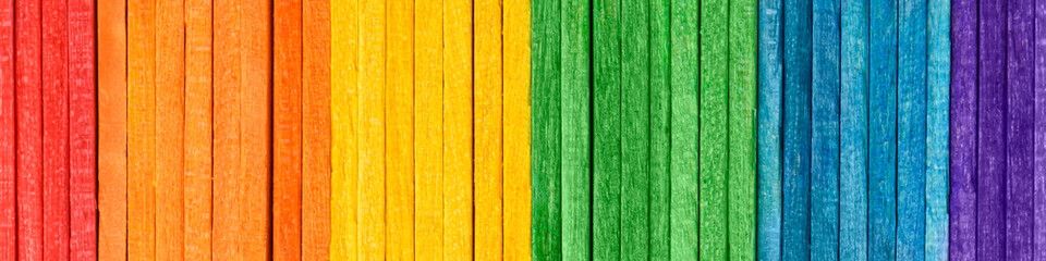 Rainbow LGBT pride flag crafted from thin wooden boards. Tolerance and diversity concept. Symbol of sexual minorities from painted wooden boards arranged vertically. Wooden rainbow banner.