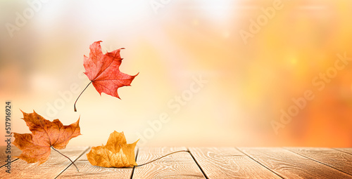 falling autumn leaves on a wooden table