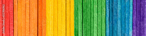 Rainbow LGBT pride flag crafted from thin wooden boards. Tolerance and diversity concept. Symbol of sexual minorities from painted wooden boards arranged vertically. Wooden rainbow banner.