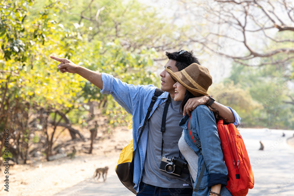 Asian young couple hiking in national park during summer