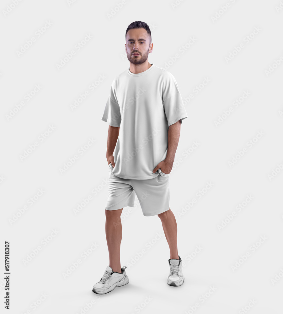 Oversized white t-shirt template, shorts on a walking bearded guy in sneakers, with hands in pockets front view, isolated on background. Oversized white t-shirt template, shorts on a walking bearded guy in sneakers, with hands in pockets front view, isolated on background.