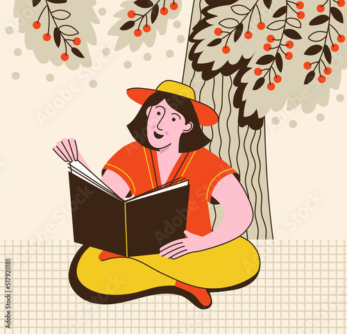 Pretty woman seating under cherry tree and reading a book. Female student on vacation. Summer time