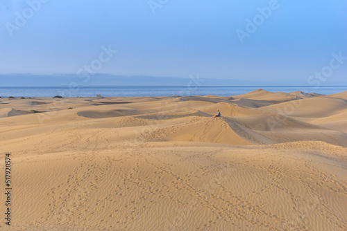 Small person in the sand dunes on a summer day